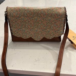 Patricia Nash crossbody nwt never used. Cognac color with flowers on front flap